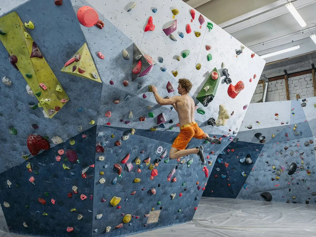 Climber in the air on rock wall