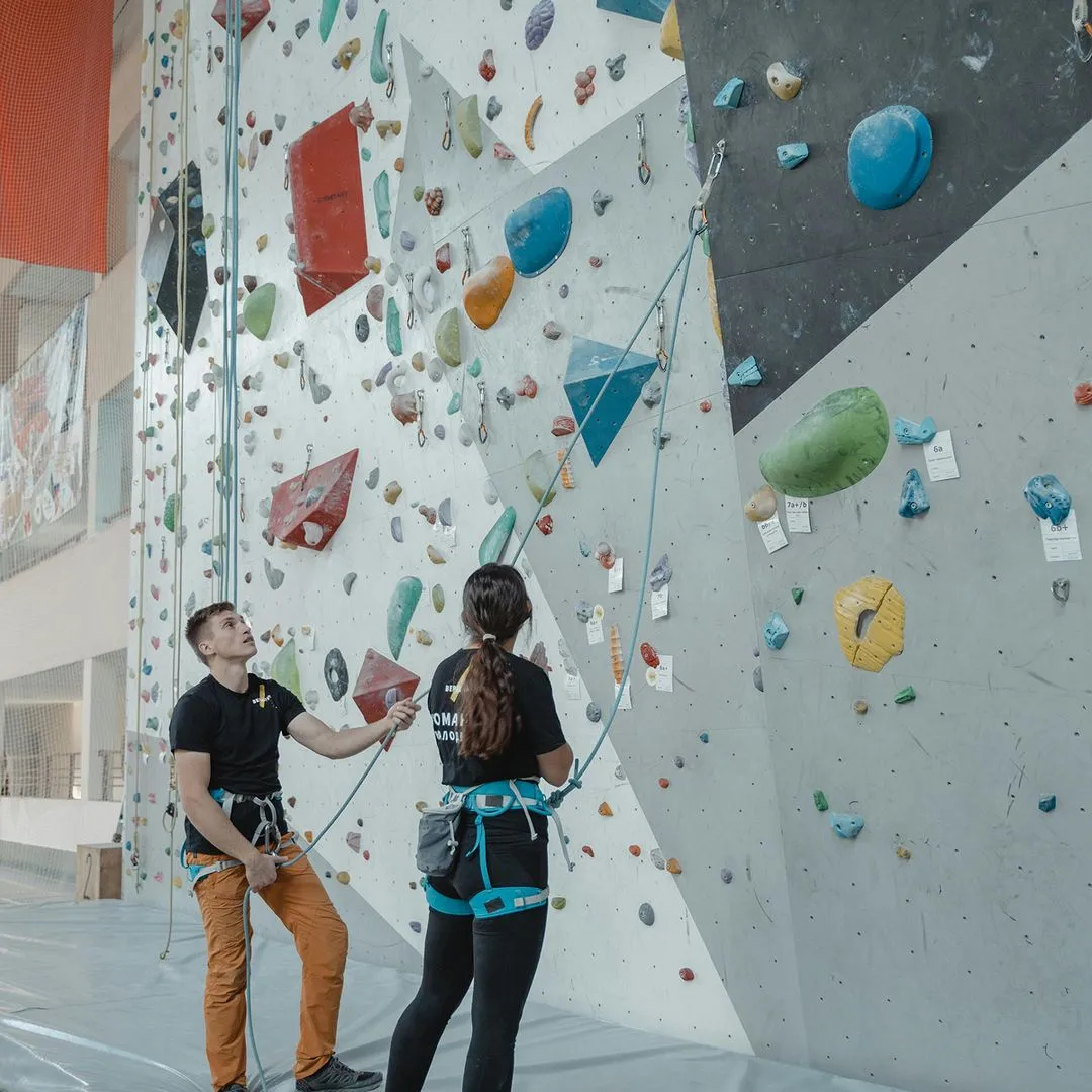 Kid climbers looking up on wall holds