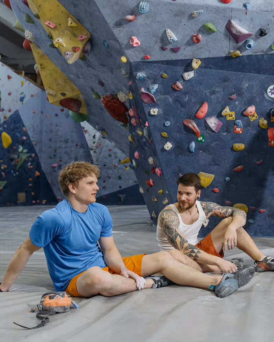 Rock climbing team hanging out next to rock wall