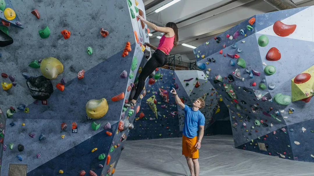 Climber assisting climber with route