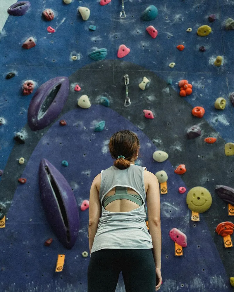 Rock climber looking up at wall