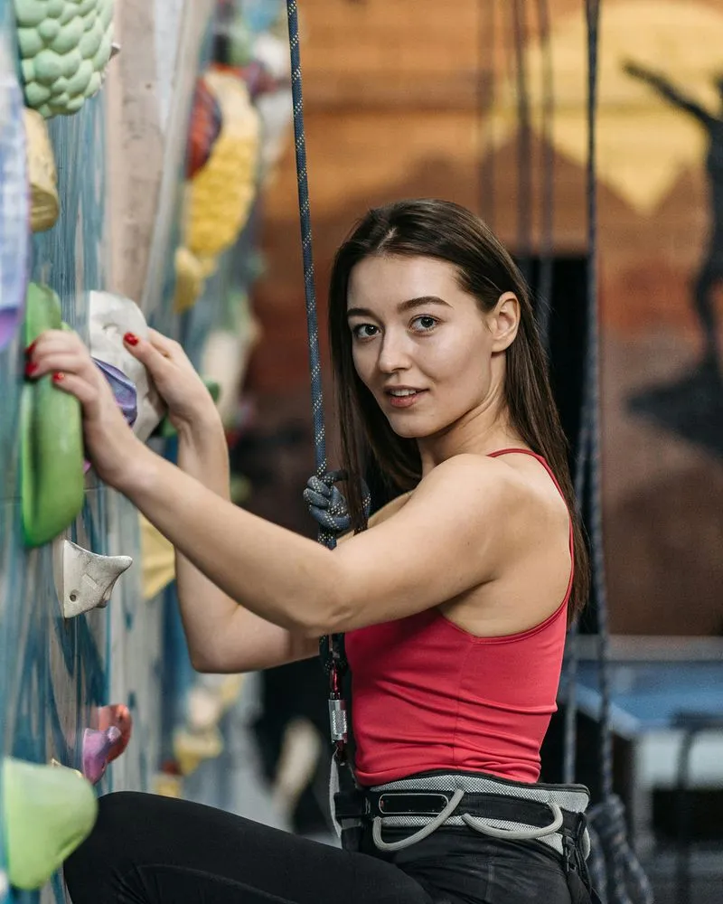 Rock climber on holding on to wall