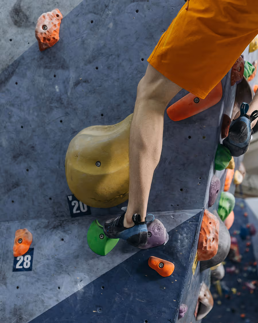 Climbers leg on rock wall