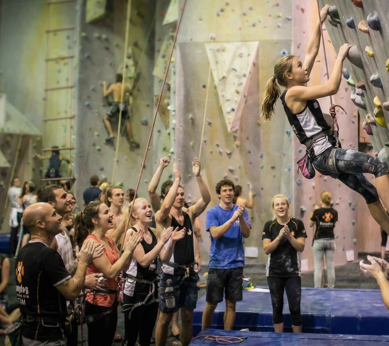 Students cheering and climbing at Hangdog Climbing Gym during Uni Night