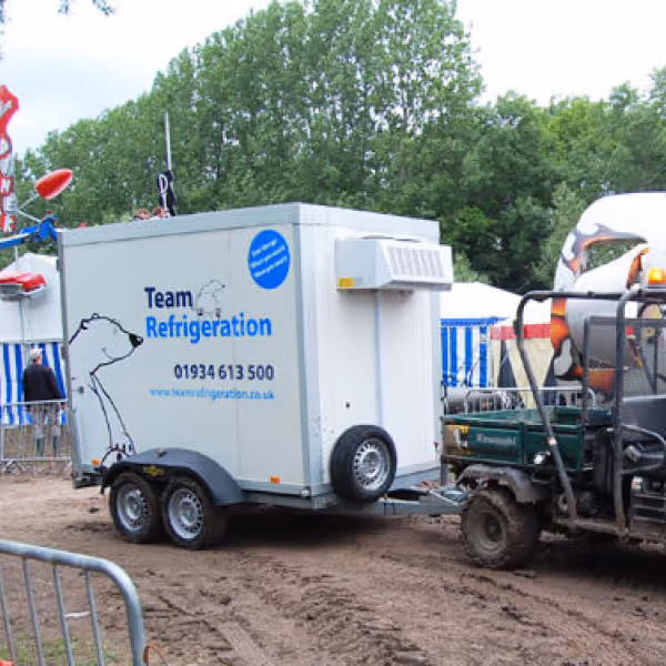 A tractor pulling a trailer with a trailer attached to it.