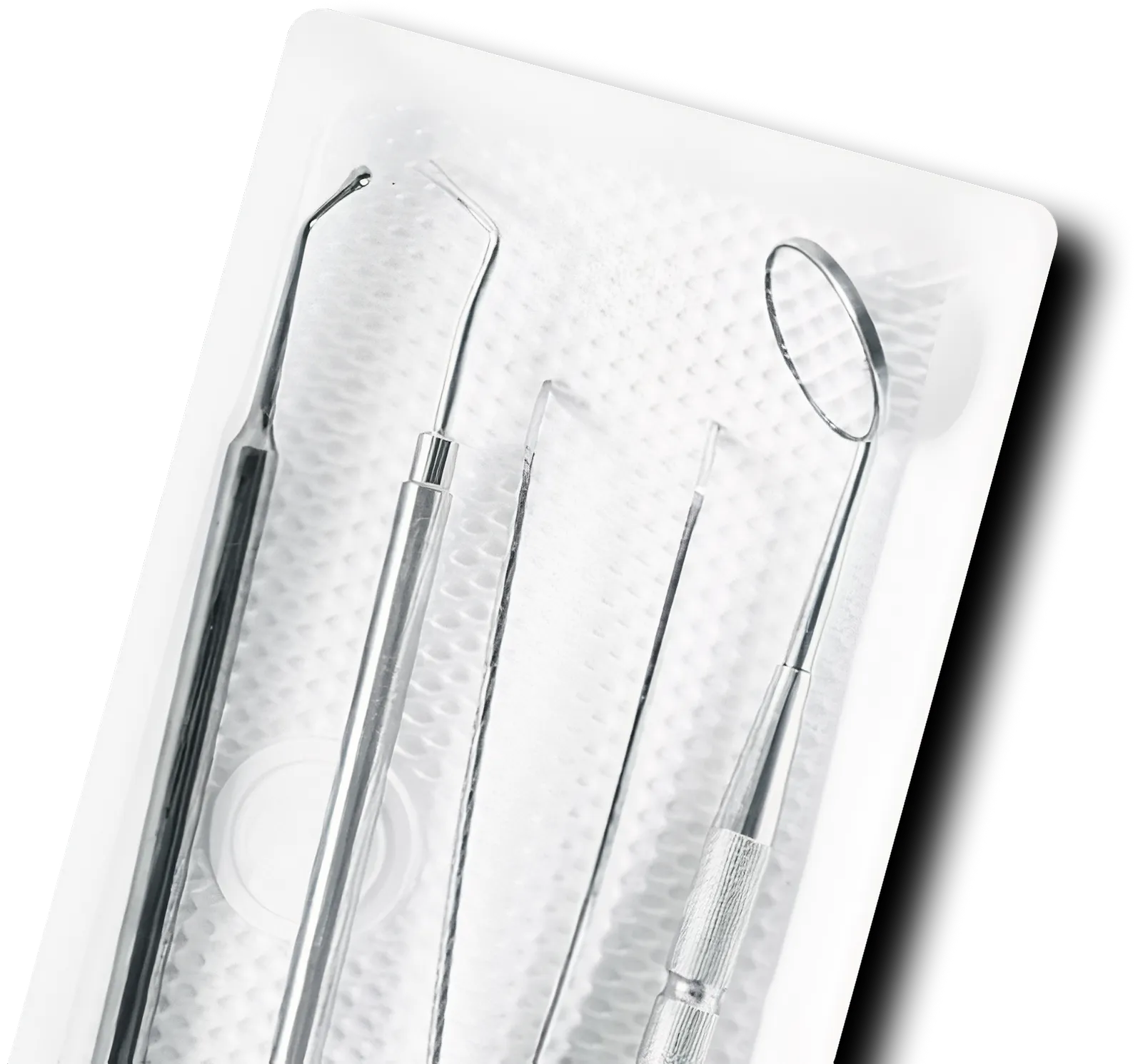Set of four stainless steel dental tools including a dental mirror, explorer, scaler, and tweezer in a white tray.