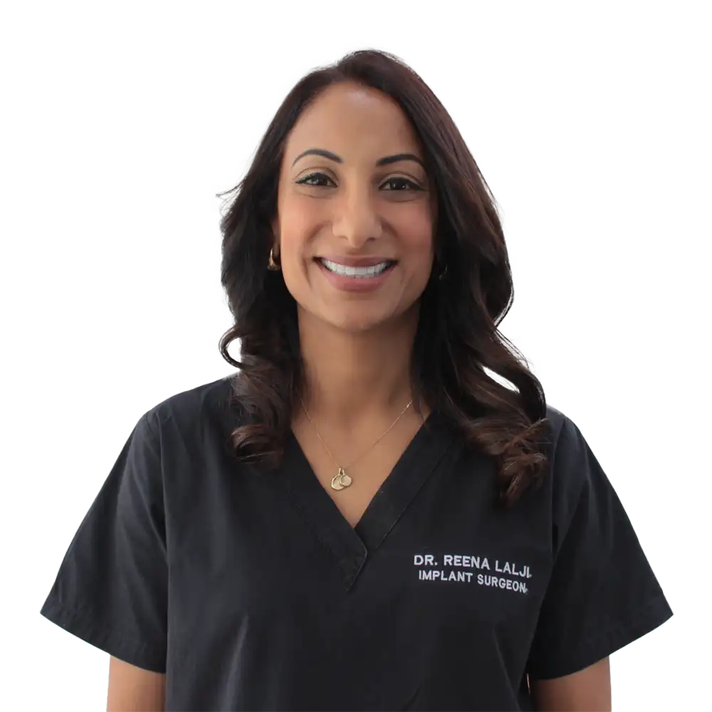 Dr Reena, implant surgeon with dark hair wearing black medical scrubs.
