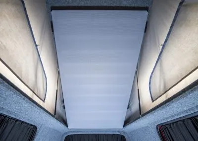Interior roof of a pop-top camper tent with fabric sides and a central white opening panel.