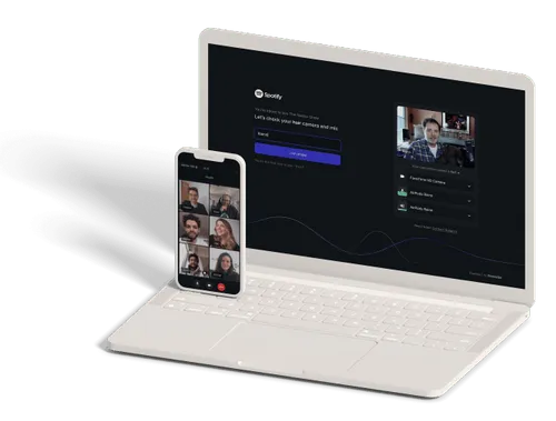 White laptop and smartphone showing a Spotify video call interface with multiple participants and camera/mic setup screen.