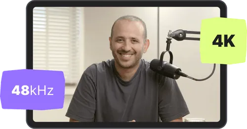 Smiling man sitting behind a microphone with '48 kHz' and '4K' text overlays.