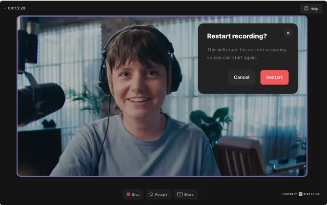 Smiling person wearing headphones in a recording interface with a pop-up asking to restart recording, showing Cancel and Restart buttons.