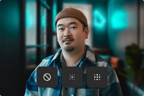 Man wearing a brown beanie and checkered jacket sitting indoors with three dark square icons below him featuring a no entry symbol and two sets of dots.