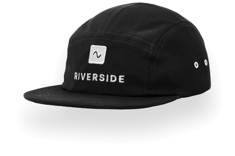 Black Riverside cap with a flat brim and white embroidered logo and text on the front.