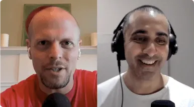 Split-screen video call with a man wearing a red shirt and AirPods on the left, and a man in a white shirt wearing headphones and smiling on the right.