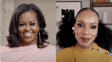 Two women smiling in a side-by-side video call, one wearing a pink top and the other a mustard-yellow top with large curly hair.
