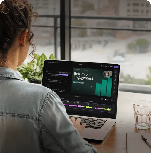 Person working on a laptop showing a video editing interface