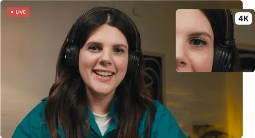 Smiling woman with long brown hair and headphones on a live 4K video call.