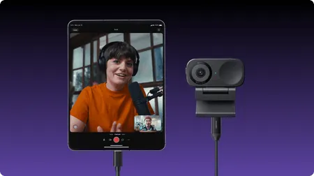 Picture of a woman and a recording camera facing the site visitor