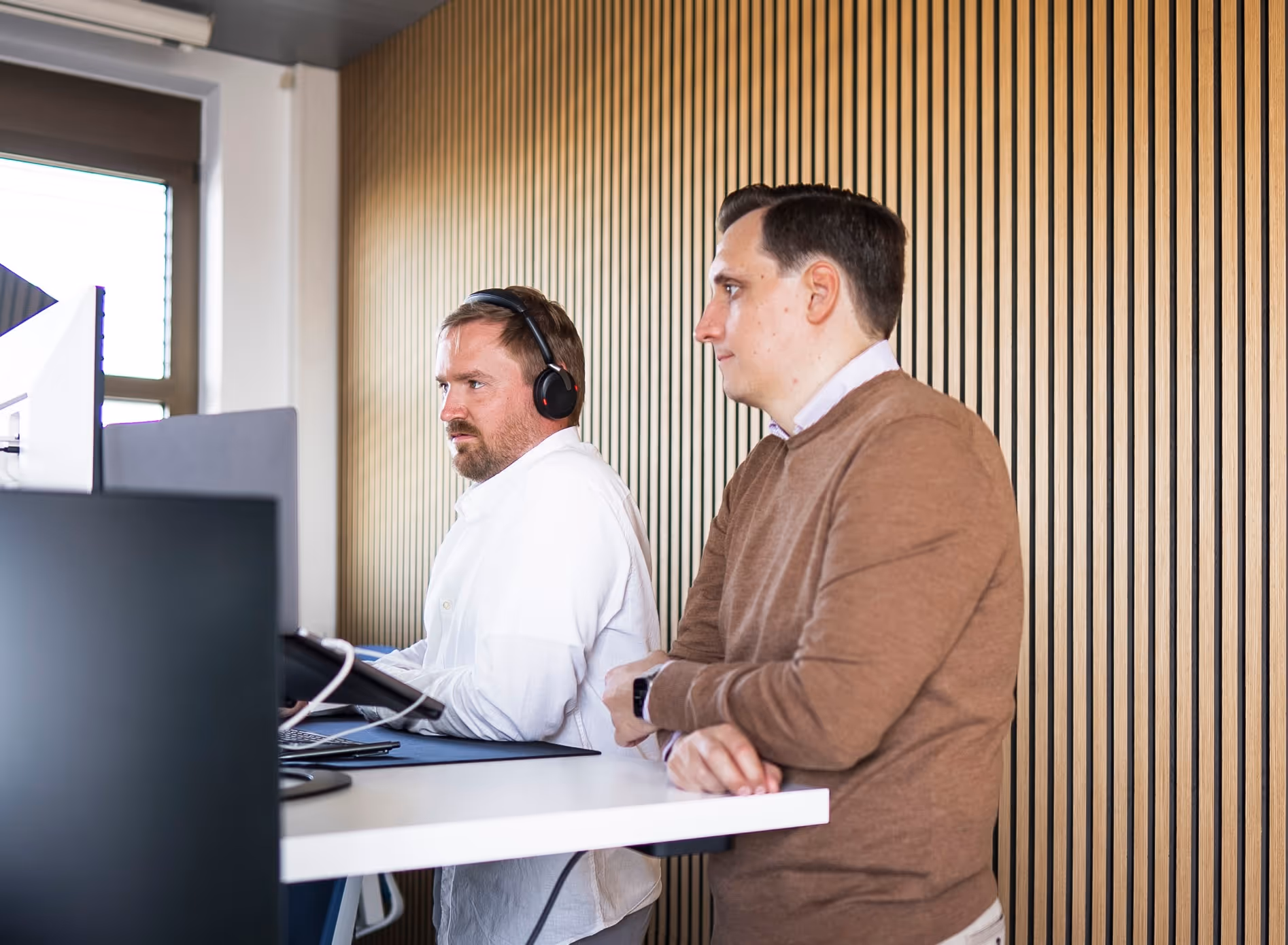 two man working on a desk in an office