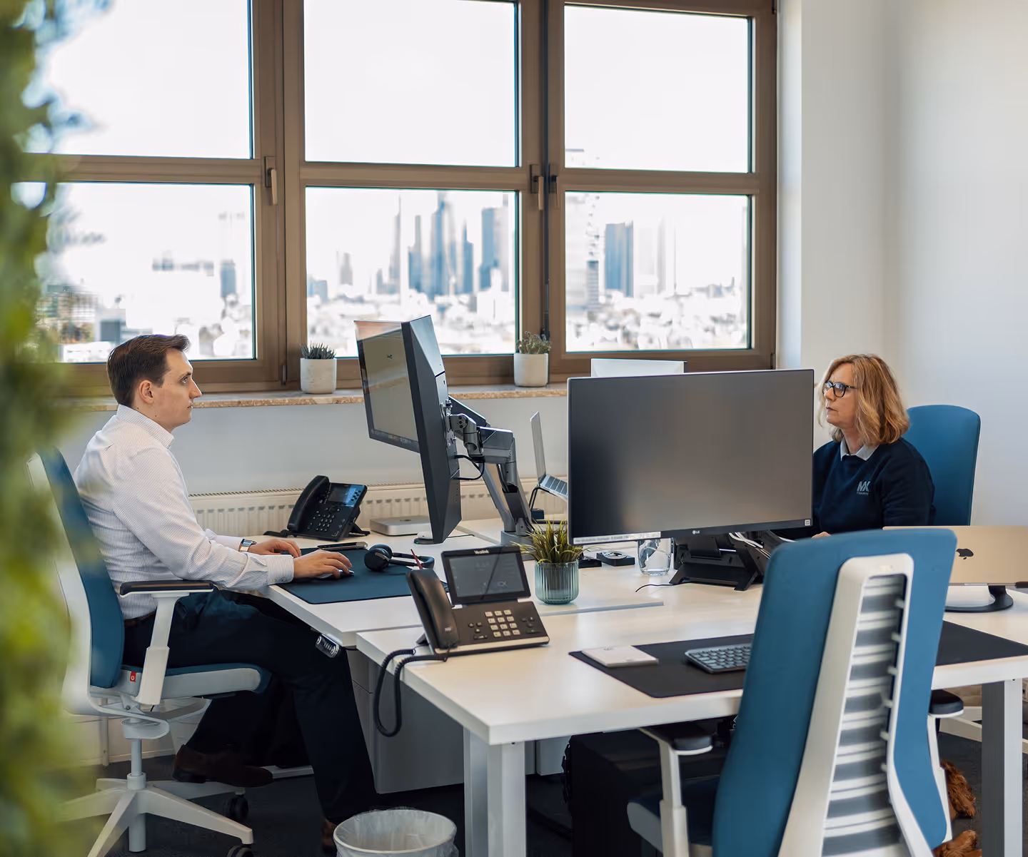 Two people working in an office