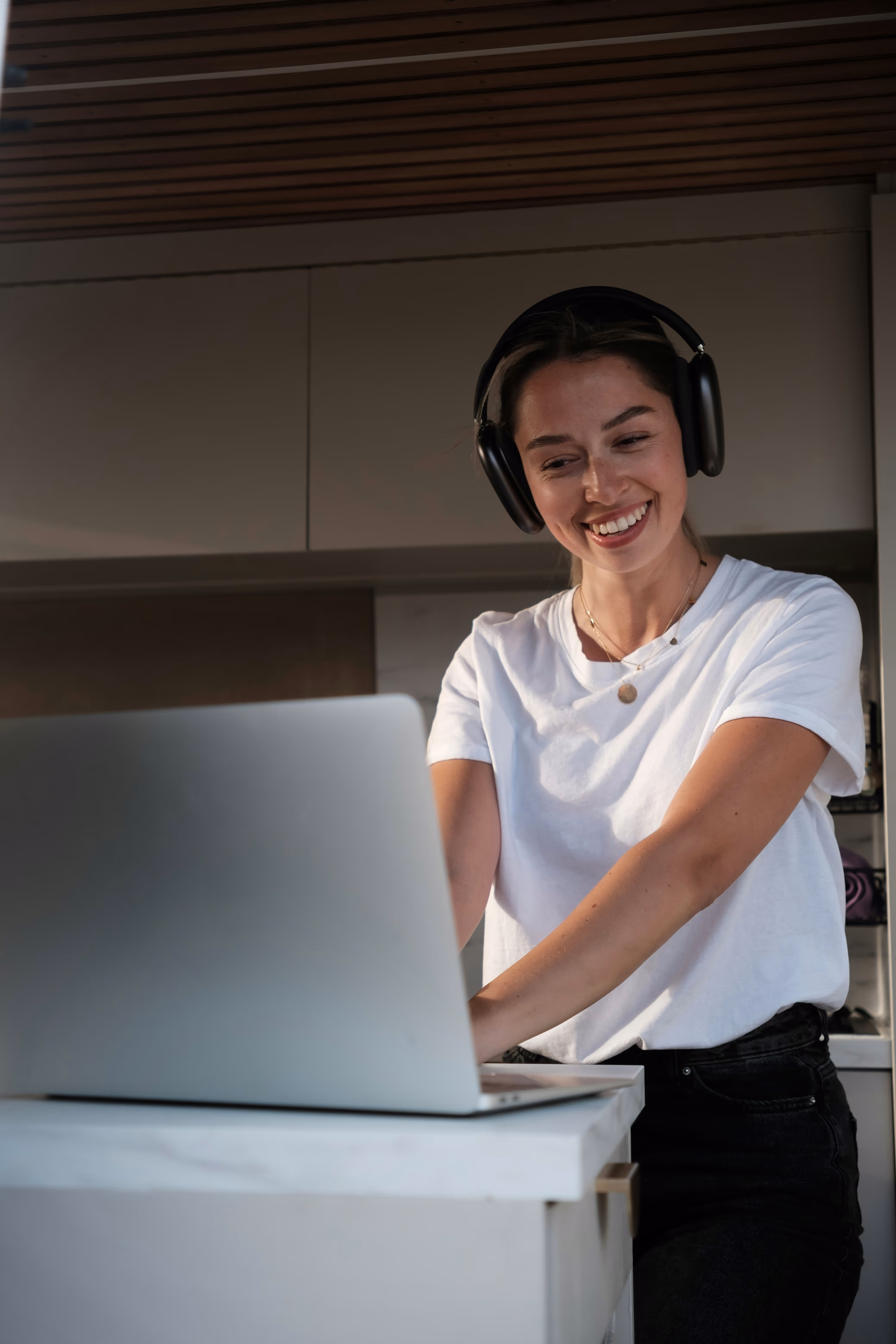 A women in a camper van working on a laptop