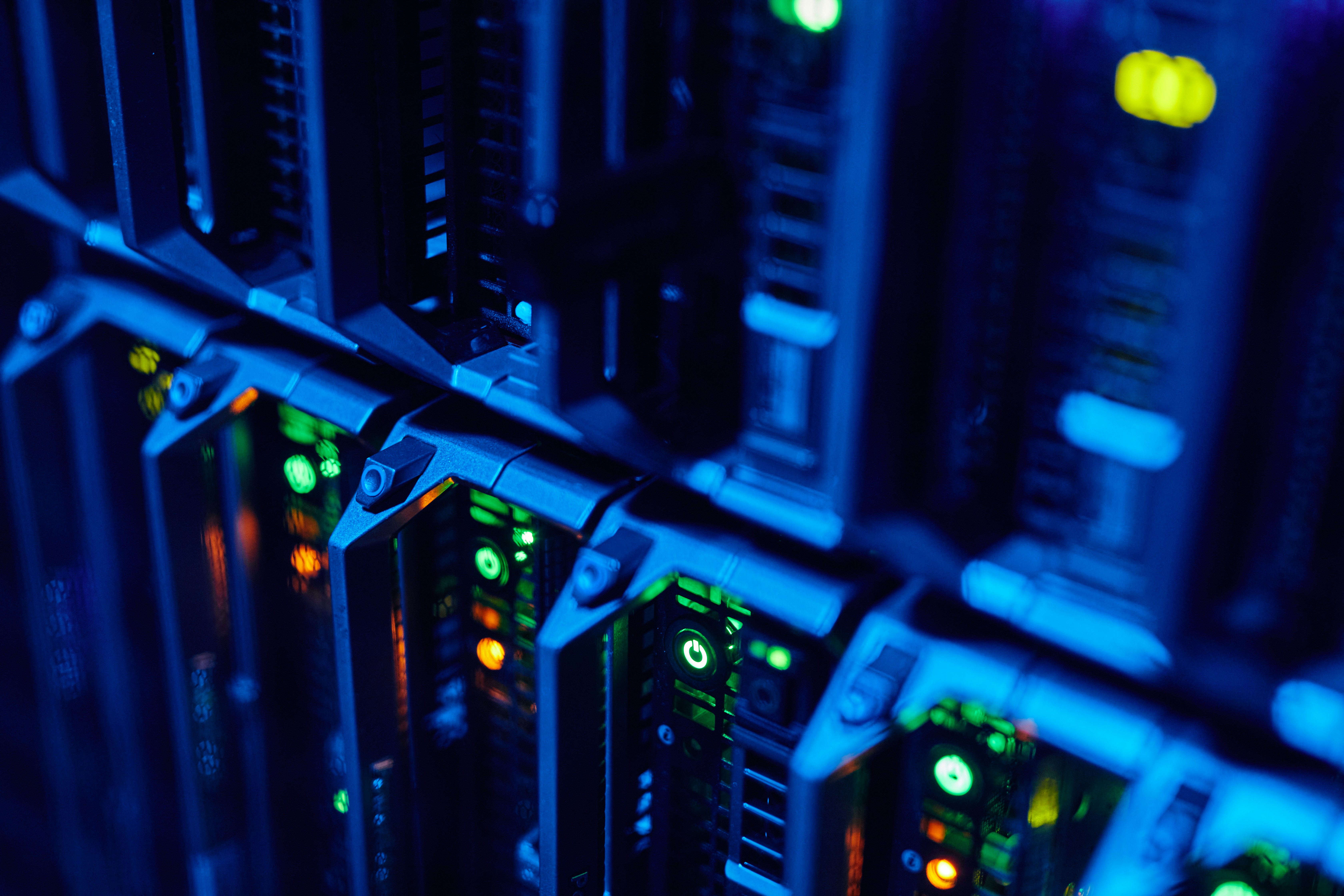 Data center server rack with glowing green and yellow status lights