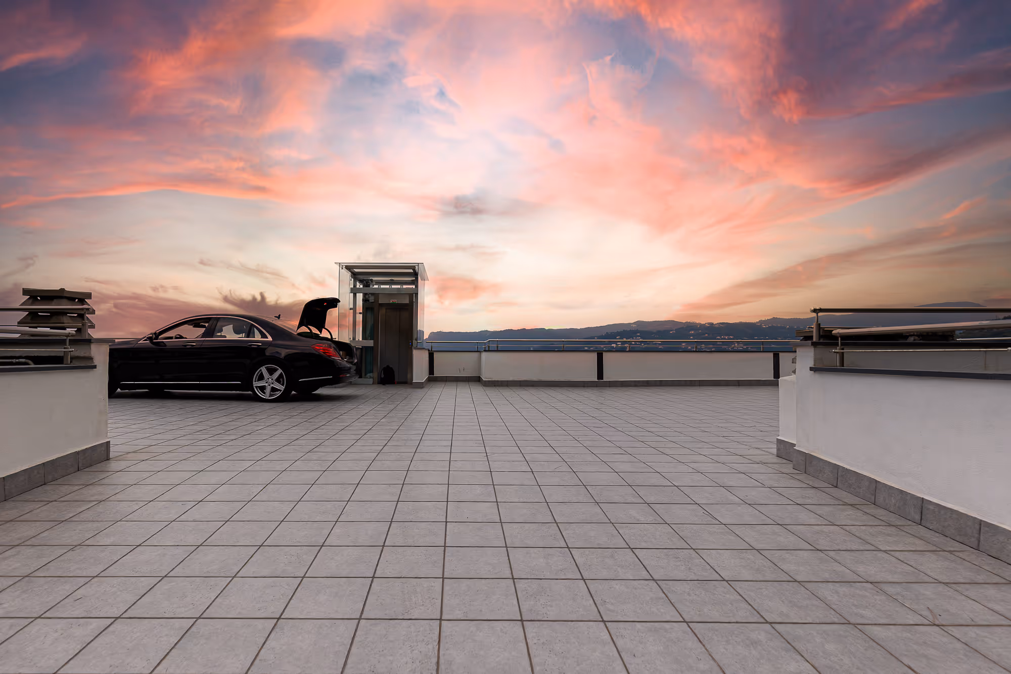 the rooftop parking lot of casa isola at sunset