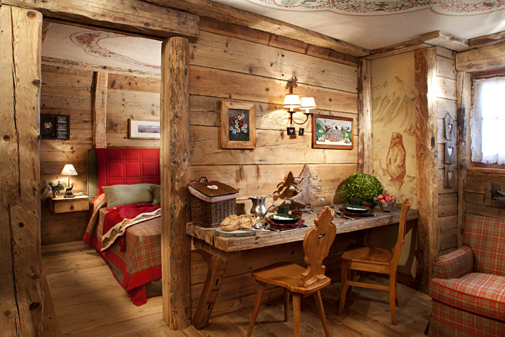 the living room of la petite of courmayeur showing the beautiful wood in which the house is made and other comforts