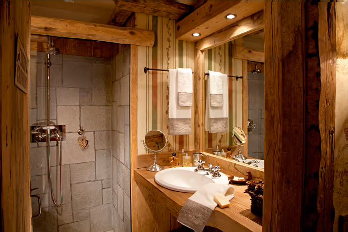 the bathroom of la petite in courmayeur made in stone and wood