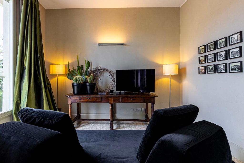 the sofa and tv in the living room of the attico di auriate in cuneo by little gems