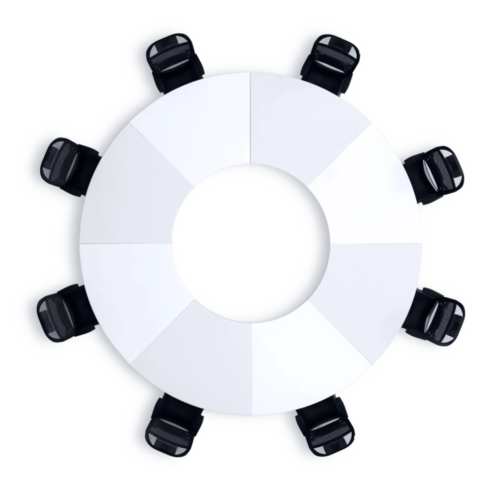 A round conference table with a circular cutout in the center, surrounded by black office chairs. The table has a white surface divided into eight sections, creating a modern design.