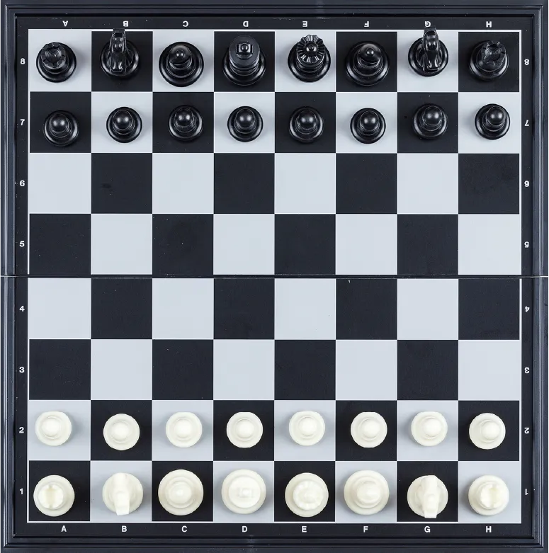 A chessboard set up for a game with black pieces on the first two rows and white pieces on the last two rows. The board is arranged in a grid pattern with alternating light and dark squares.