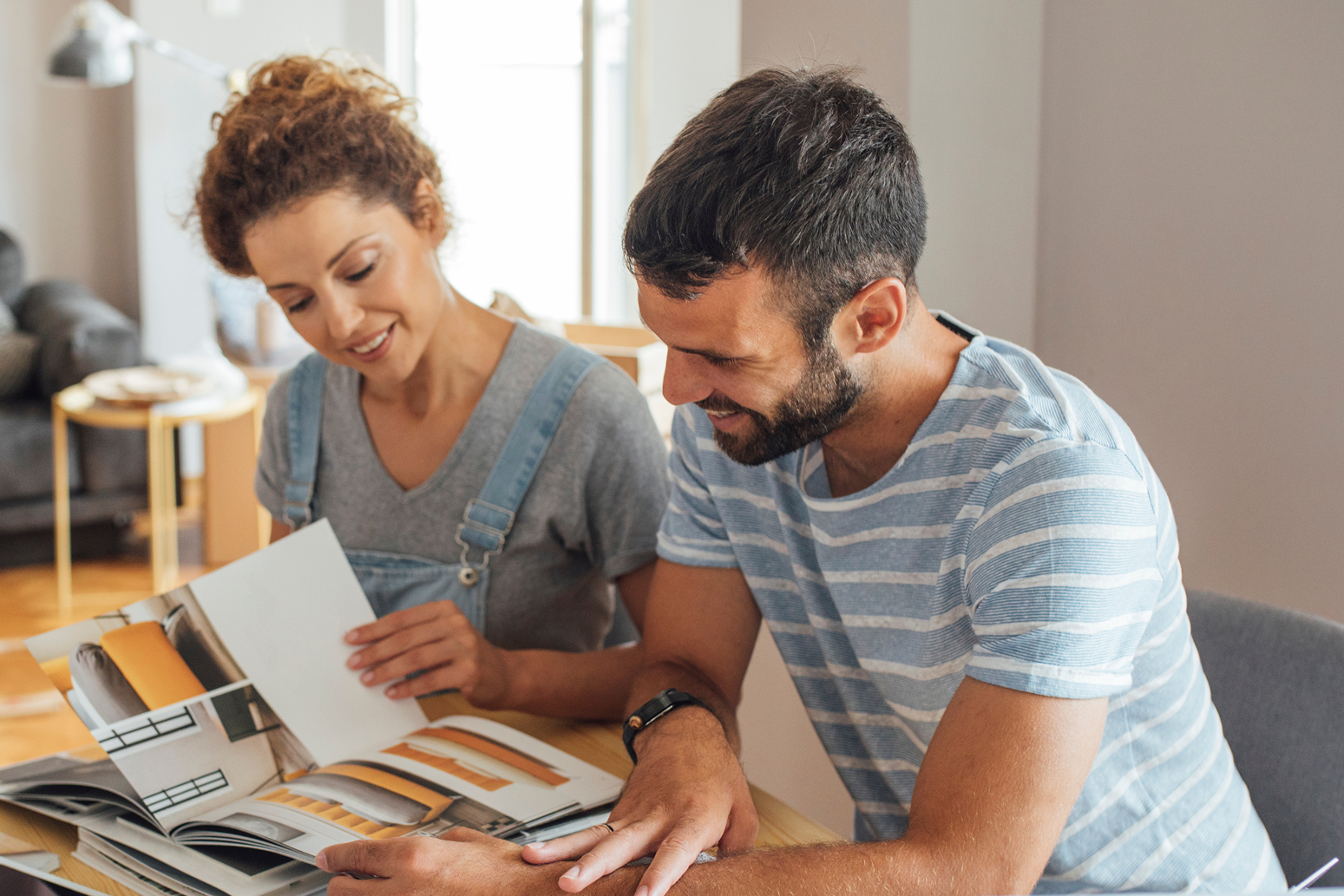 A man and a woman looking at a book.