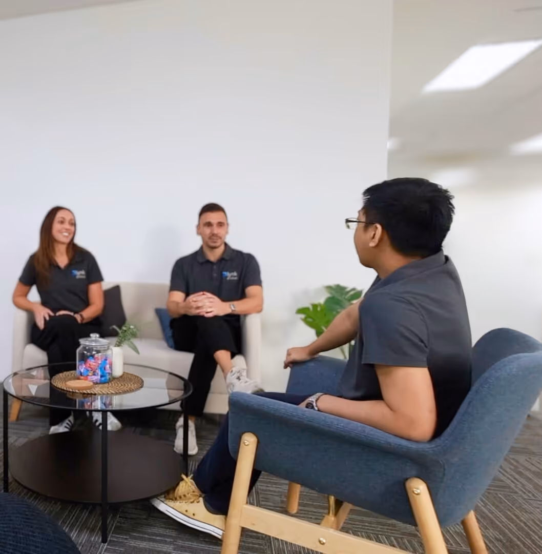 Lynk Global team members in a planning discussion, reviewing client needs to assign the right admin or bookkeeping support.