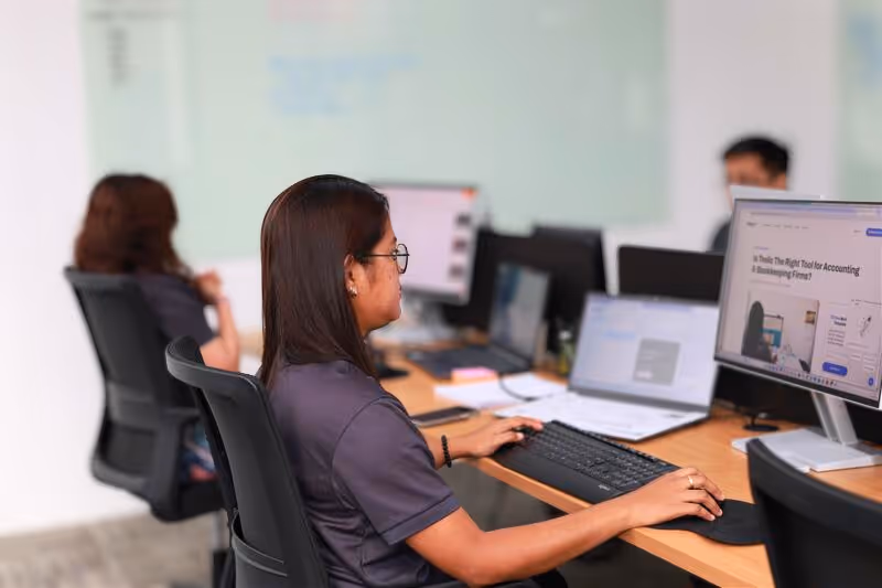 Lynk Global team members working at their desks in the office, providing bookkeeping and admin support services