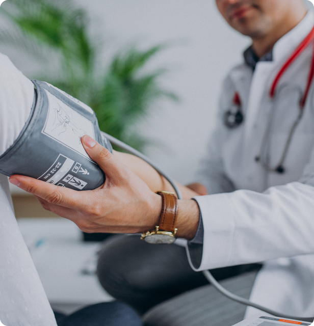 A medical scene showing a doctor taking blood pressure.