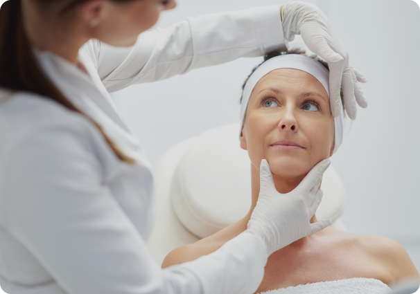 A professional performing an aesthetic treatment on a client's face.