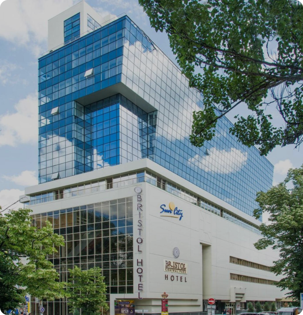 BRISTOL HOTEL Building structure with detailed facade and surrounding foliage elements.