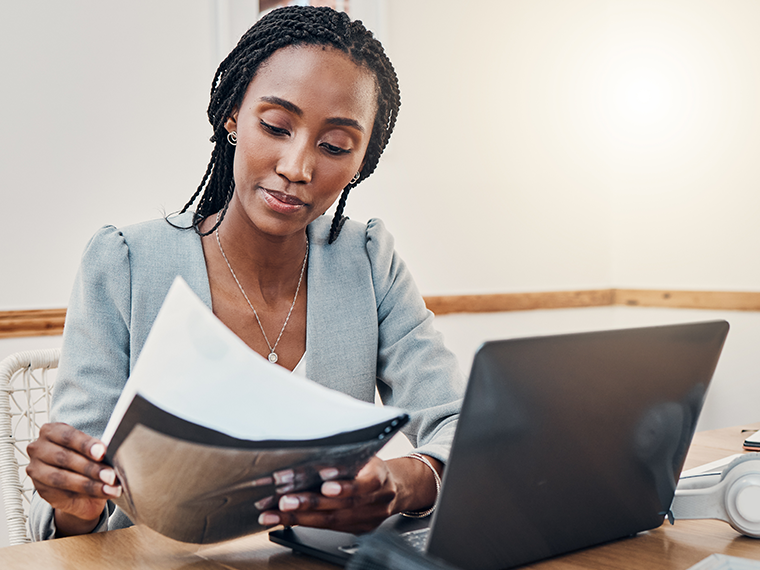 Focused Black woman doing a background check on employement form