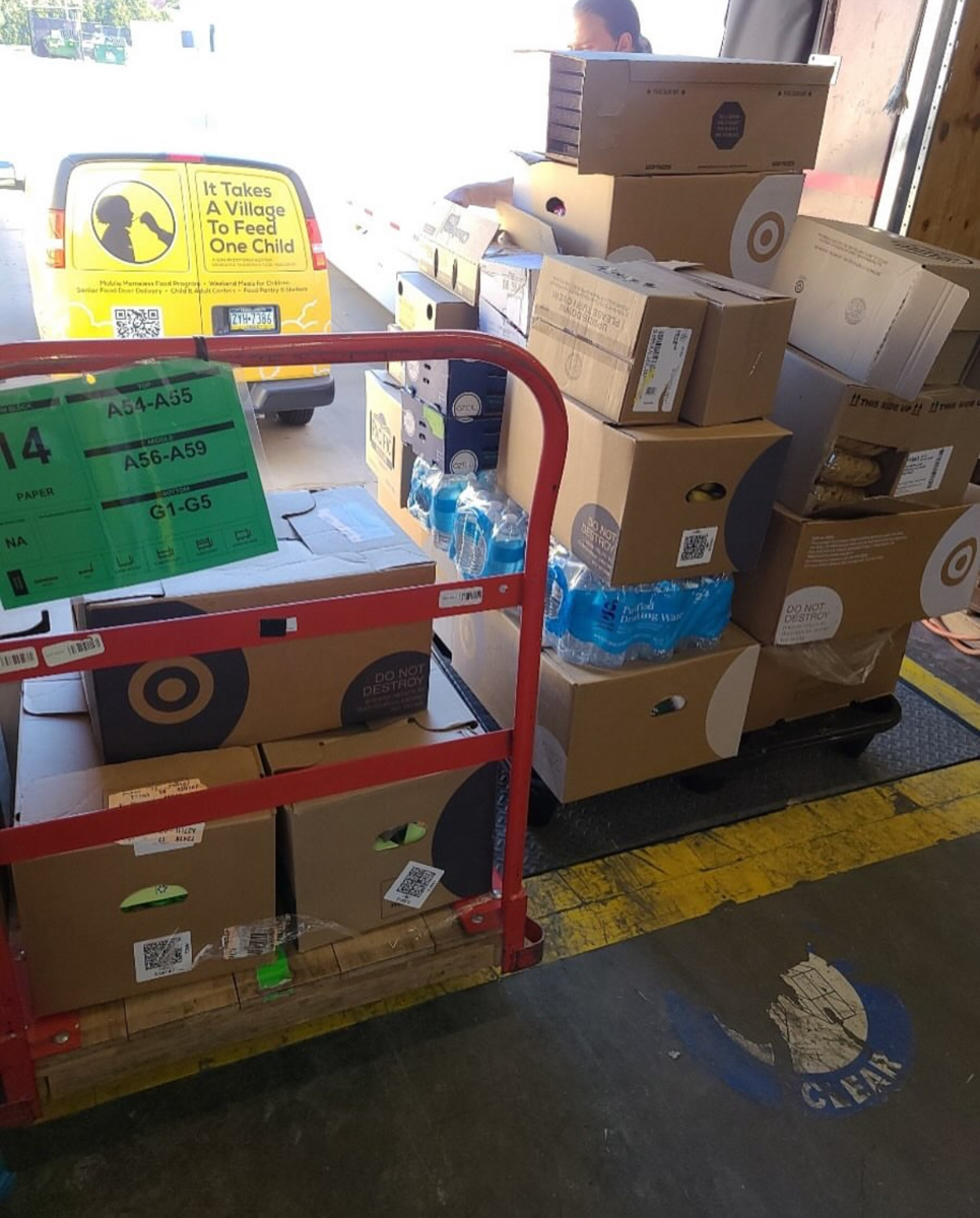 Philadelphia volunteers preparing and serving meals for children at It Takes a Village To Feed One Child