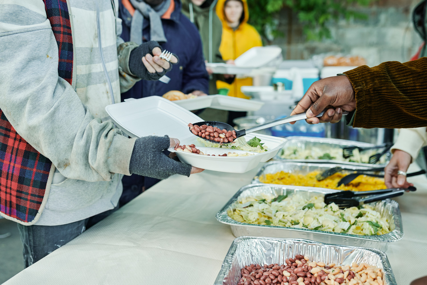 Homeless in Philadelphia receiving nutritious meals through the Mobile Homeless Food Program, a community program run by the non-profit organization It Takes A Village To Feed One Child.