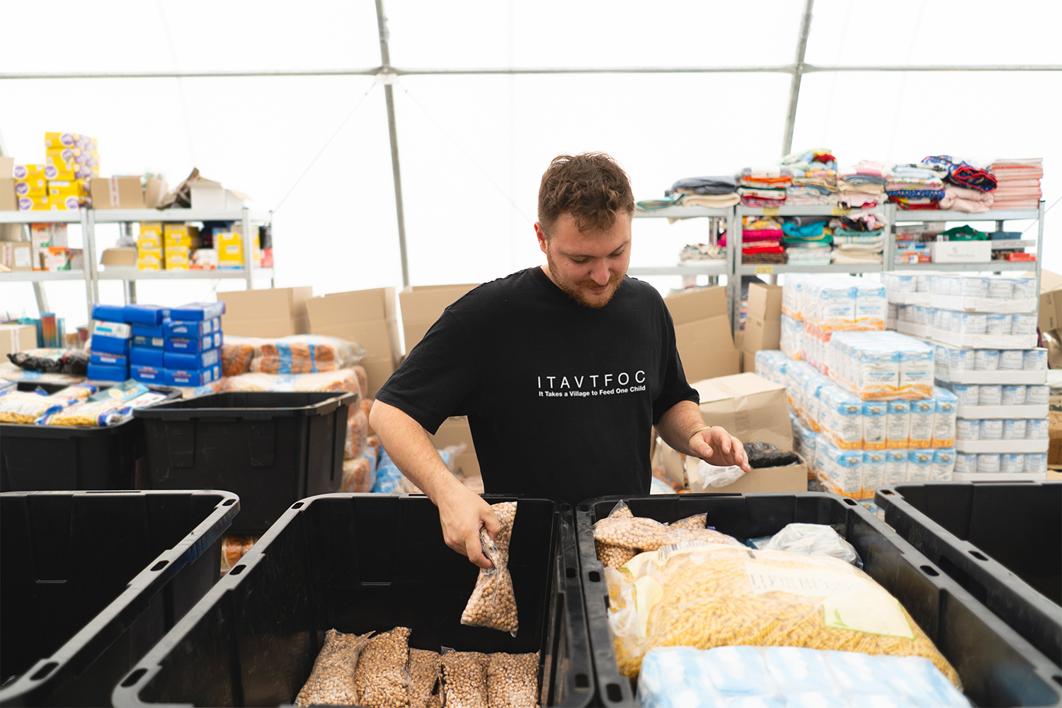 A Volunteer organizing food boxes for the Summer Food Service Program, a program providing healthy meals and snacks to children in need while the school is not in session