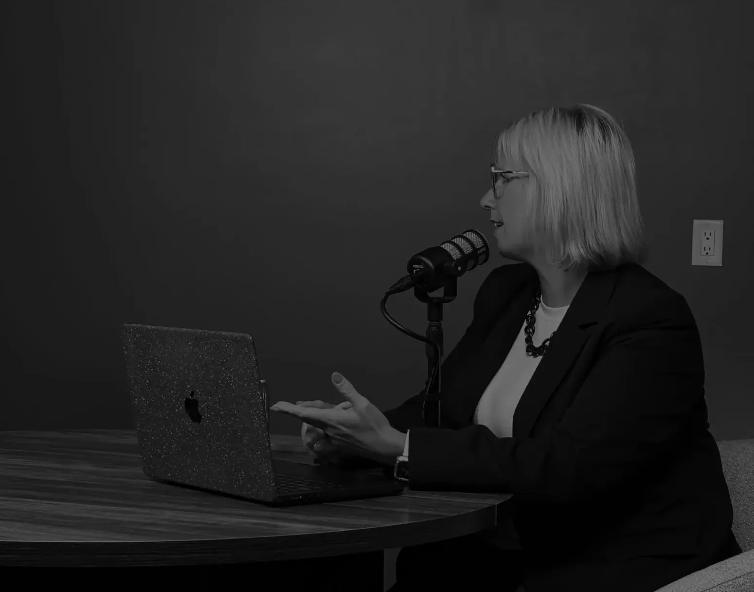 podcast host and guest sitting at podcast table