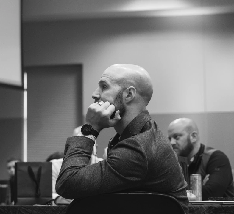 man listening intently at speaker