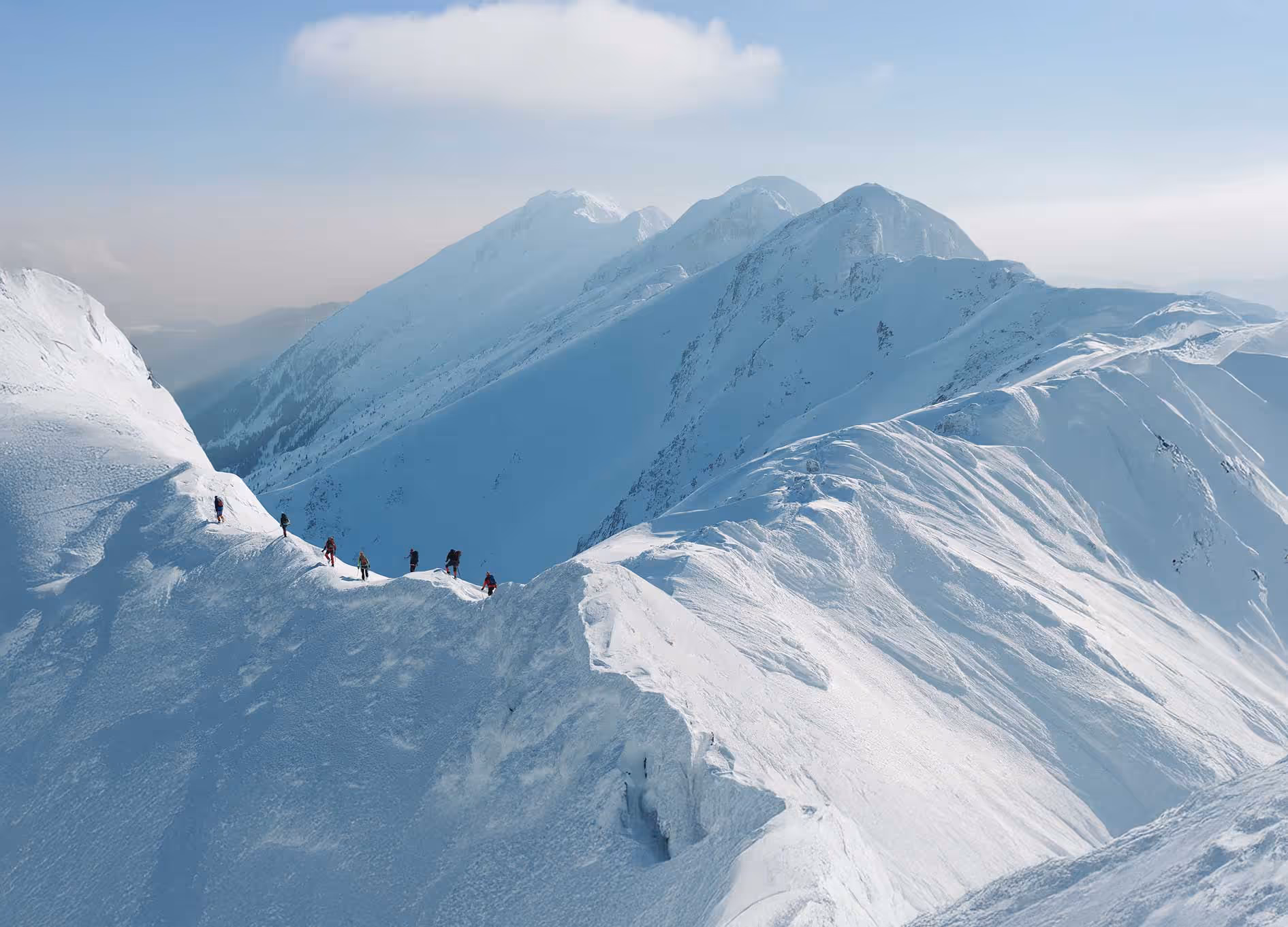Hikers on a snowy mountain.