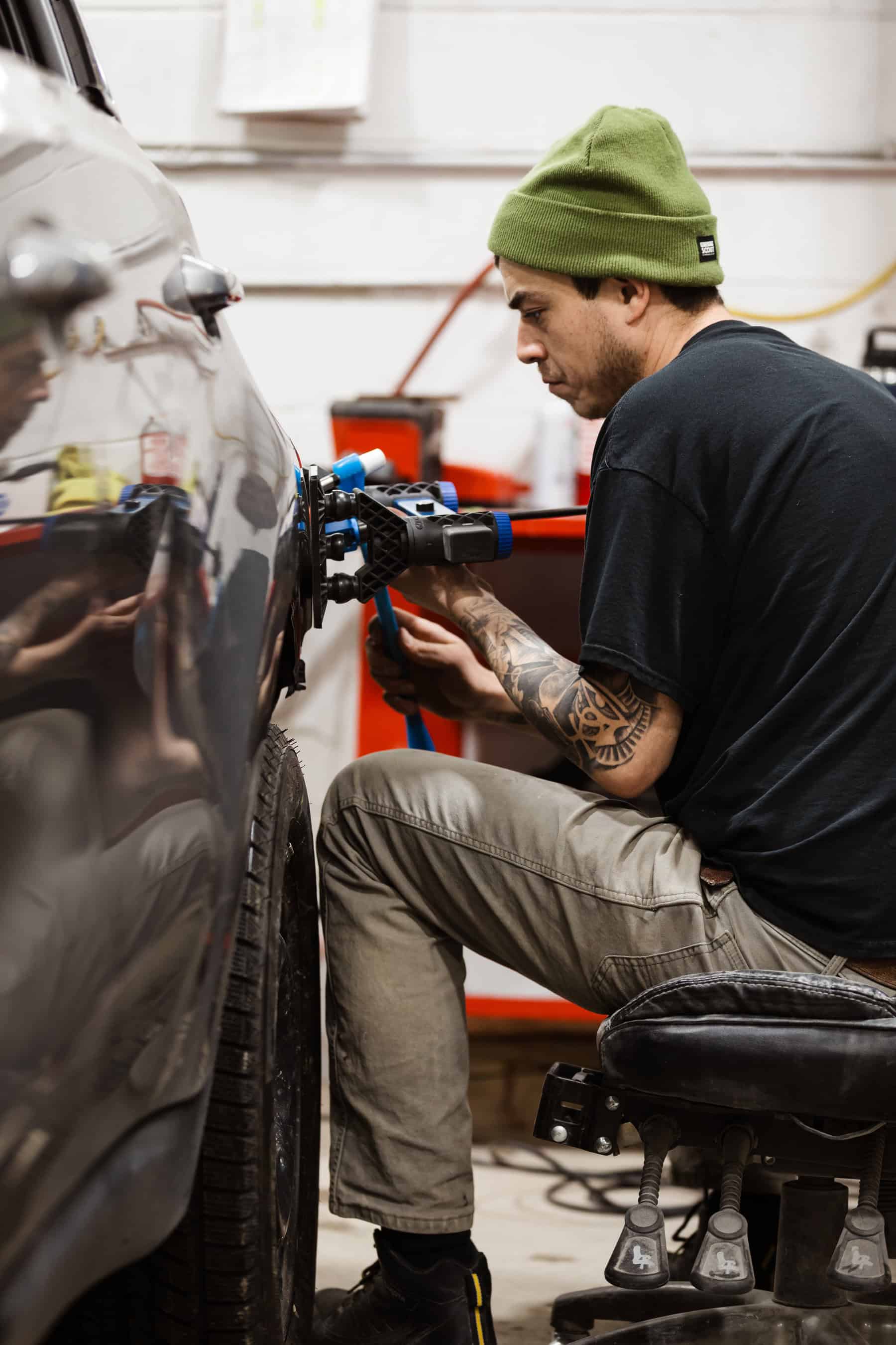 A man working on a car in a garage.