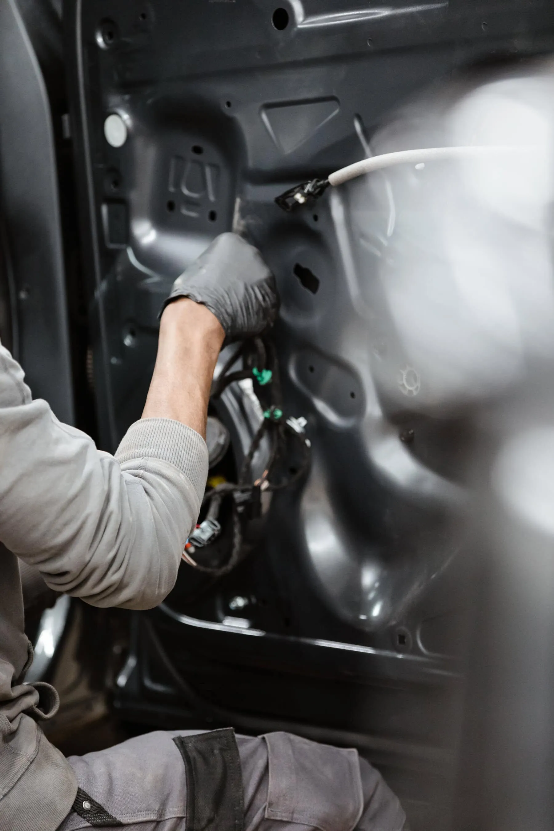 A man working on a vehicle's door panel.