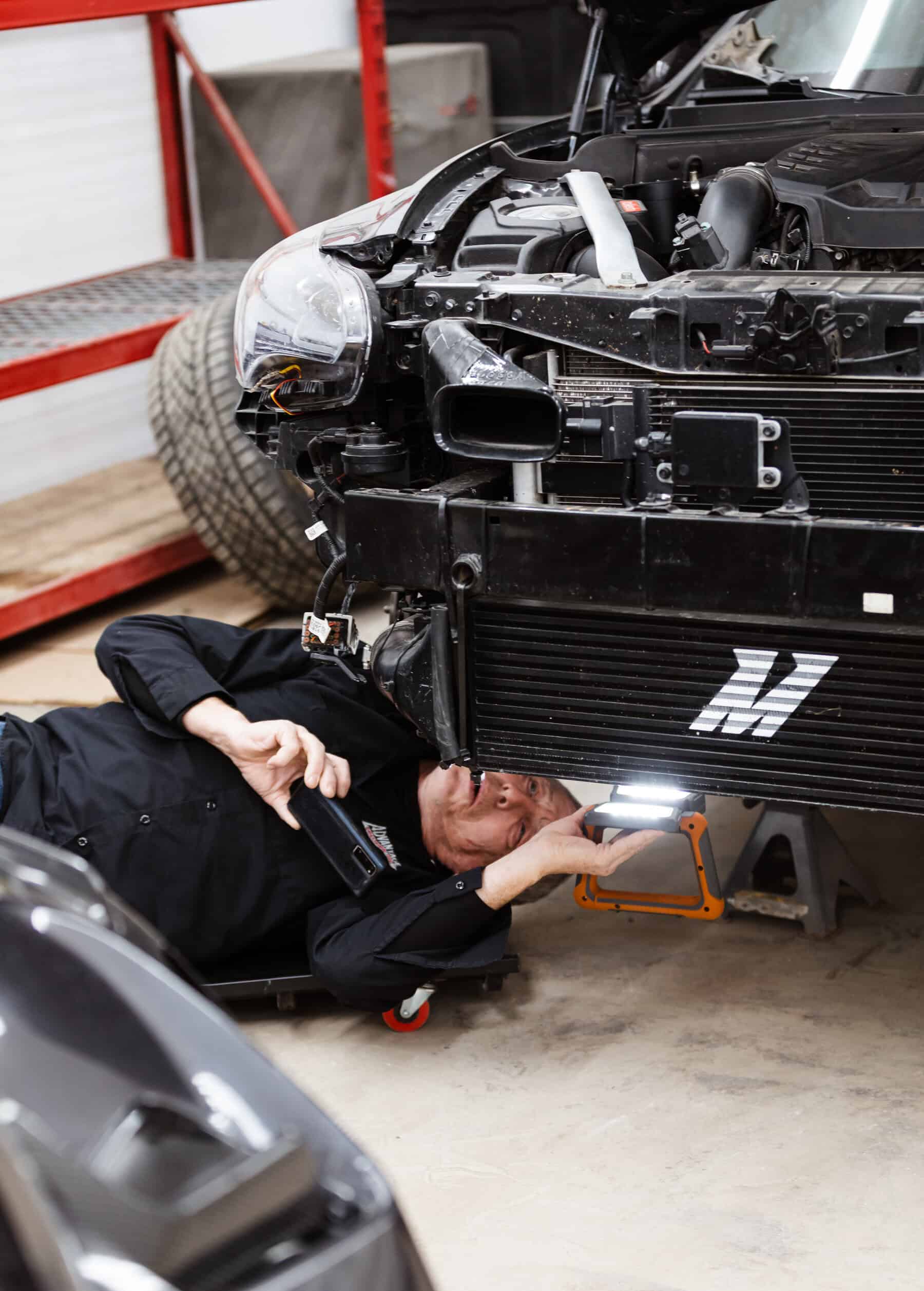 A man working on a car in a garage.