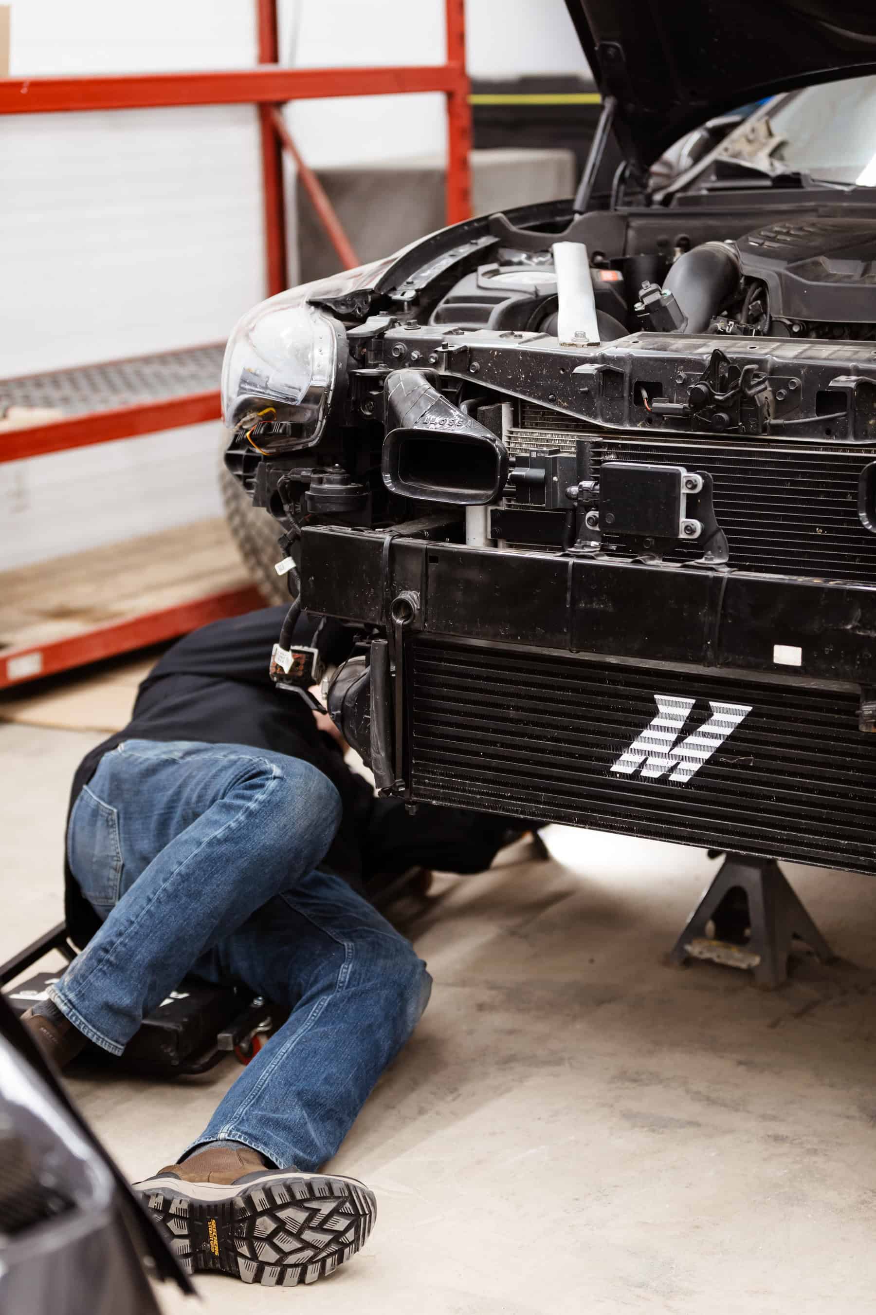 A man working on a car in a garage.