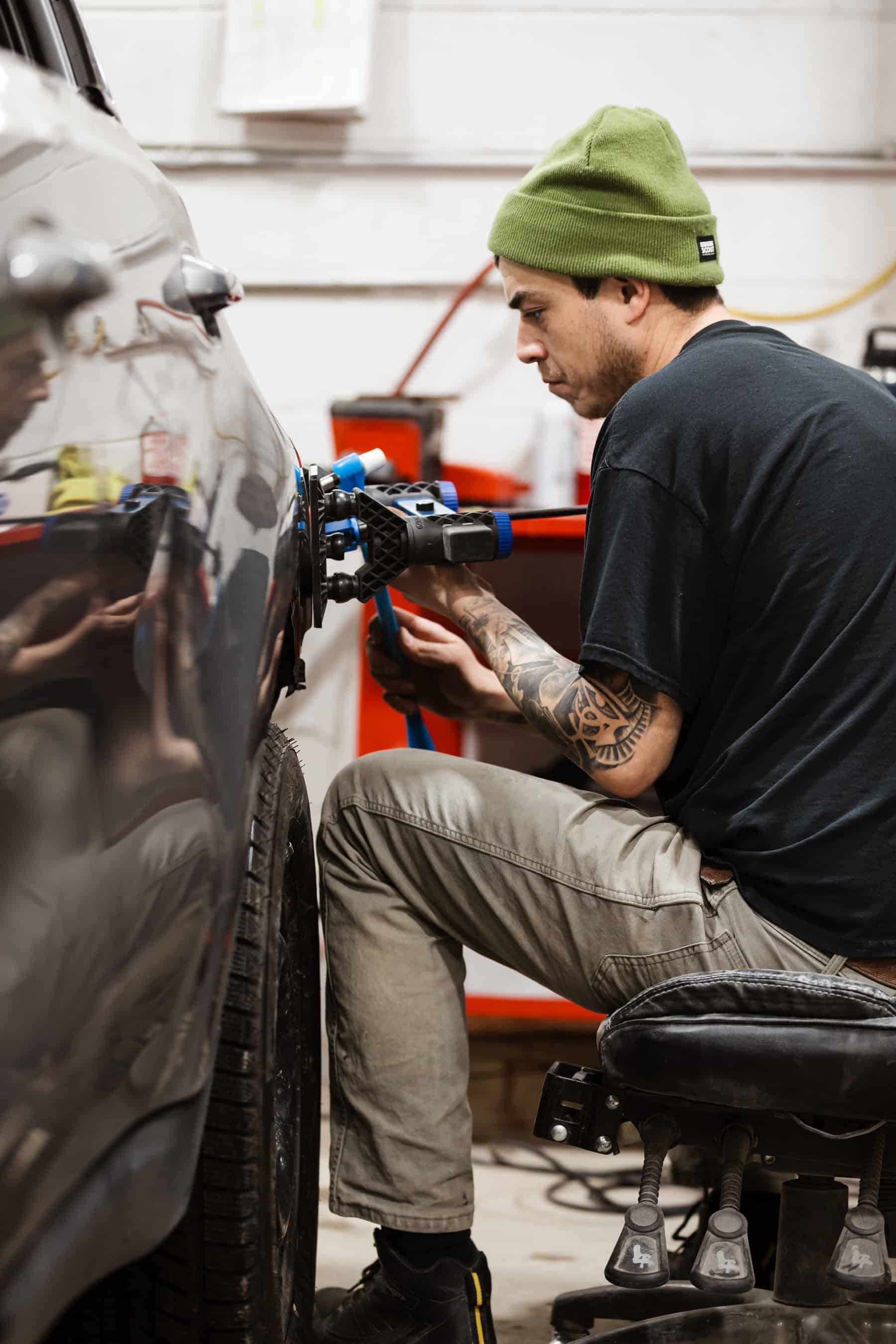 A man working on a car in a garage.